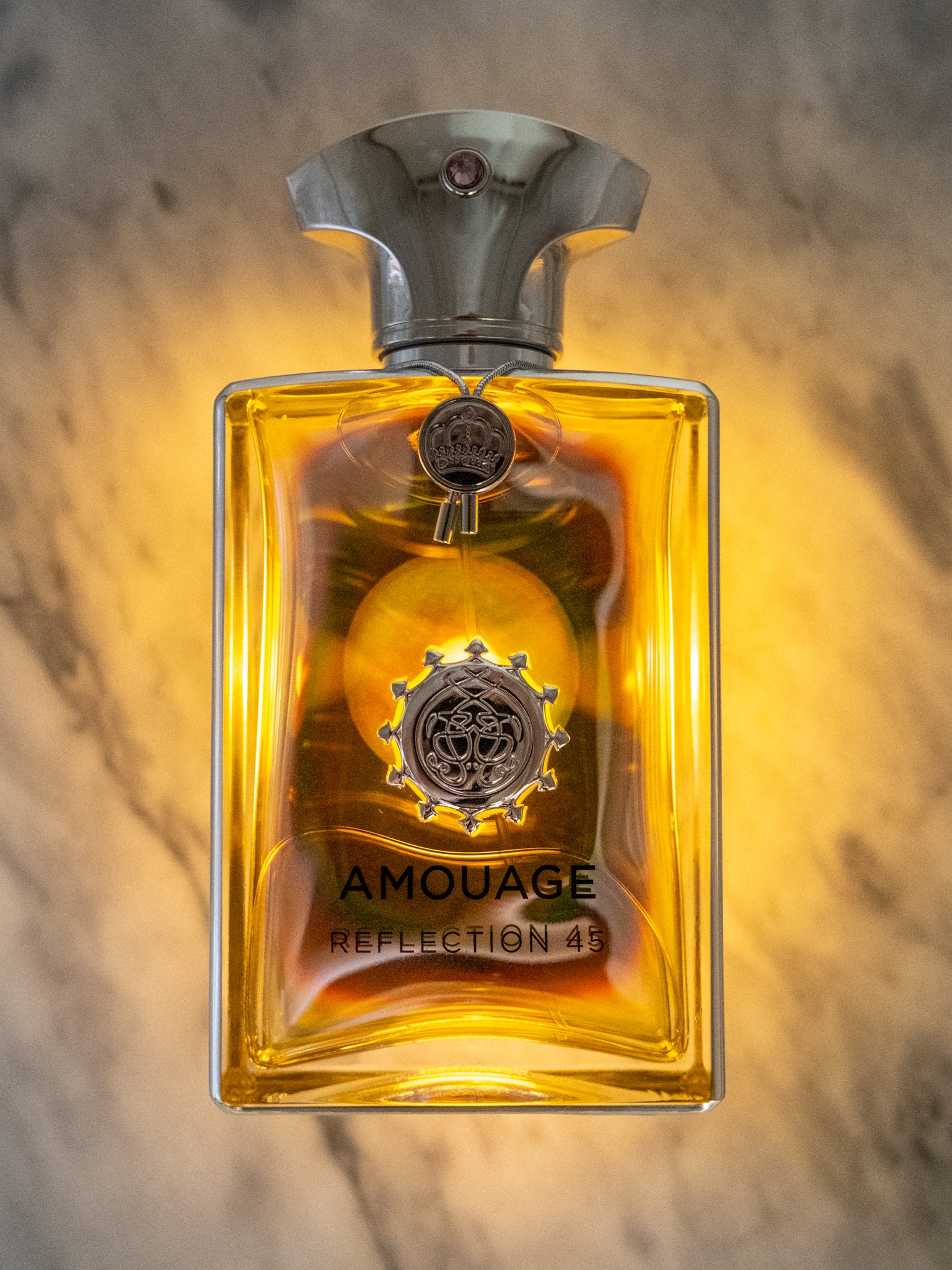 Amouage Reflection 45 bottle backlit from above